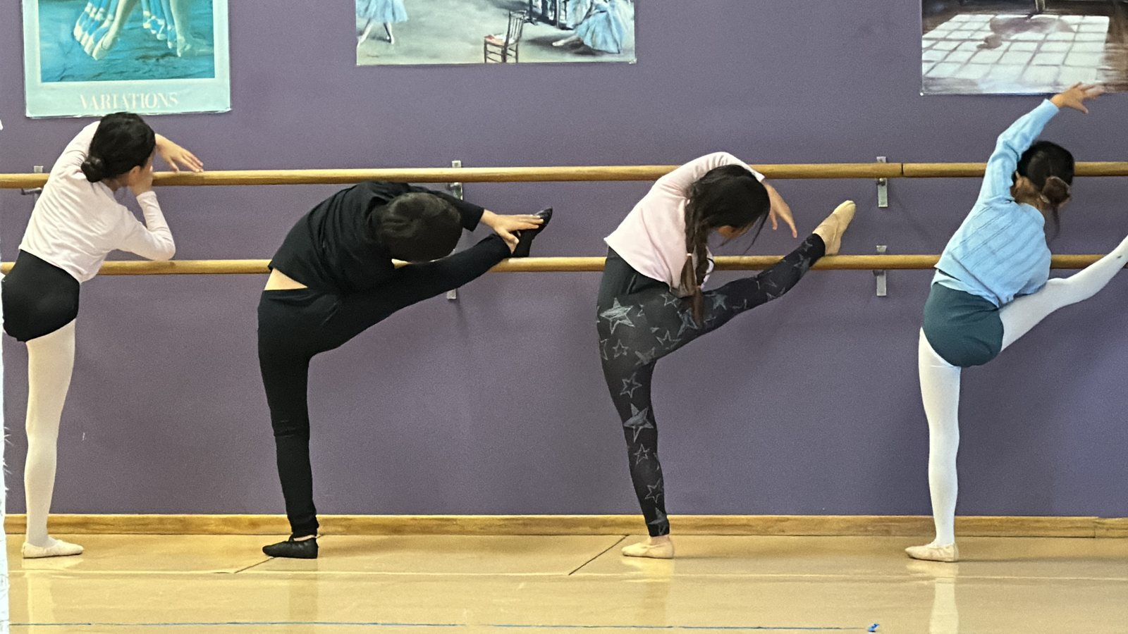 Stretching at the barre in ballet class